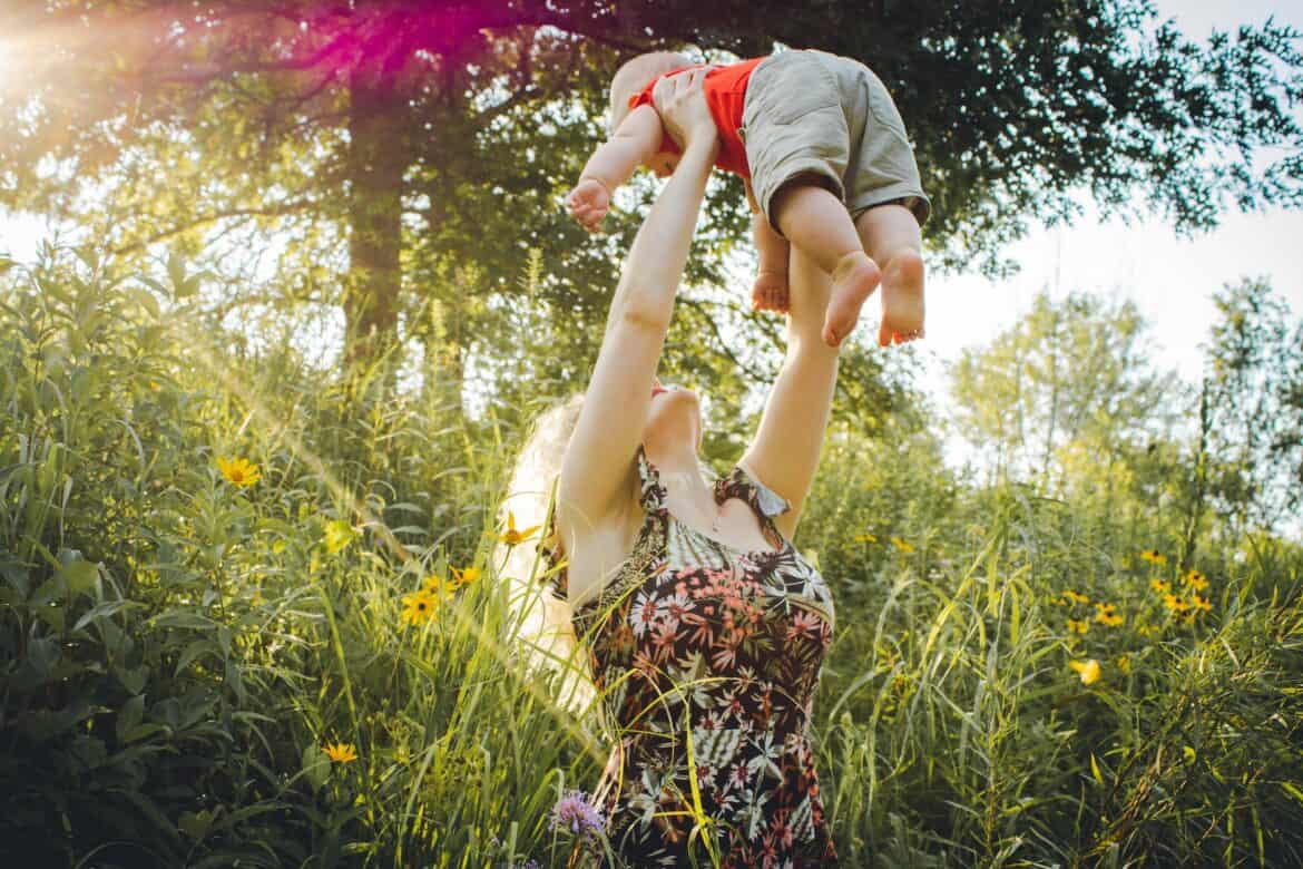 mother lifting her baby